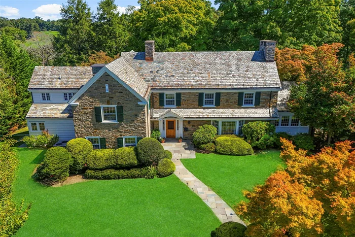 Nestled on a lush half-acre in one of Larchmont&rsquo;s most sought-after cul-de-sacs, this 1931 Moody-built Center Hall Colonial blends historic charm with modern elegance. The stone exterior and timeless architecture are complemented by original details and custom craftsmanship. Upon entering, a grand foyer with soaring two-story ceilings and abundant natural light greets you. Custom millwork, including intricate wood paneling and original archways, adds character and sophistication throughout. The oversized living room is a focal point of the home, featuring custom built-in shelves, a large picture window, a gas fireplace, and French doors leading to a private back patio for alfresco dining. The private office is ideal for those who work from home, with custom built-ins and direct access to the back patio. The formal dining room features an original built-in bar and a wood-burning fireplace, perfect for intimate dinners or large gatherings. The spacious kitchen combines classic charm with modern functionality. An oversized island provides ample workspace, while top-tier appliances like the Viking 6-burner range, double ovens, and Sub-Zero fridge make it a chefâ€™s dream. Custom cabinetry offers plenty of storage, and the adjacent sitting area and family room provide perfect spaces for casual family gatherings. Large windows flood the family room with light, creating a welcoming and open environment. Upstairs, the primary suite offers luxury and privacy, with a dedicated hallway full of built-in closets. The private dressing area connects to the primary bath, which features a double vanity, marble counters, radiant heated floors, a soaking tub, and a steam shower with dual heads. Two additional family bedrooms are well-appointed with custom shelving, built-ins, and en-suite marble bathrooms. A large walk-in linen closet adds extra convenience. The basement features a wet bar, a cozy den with a working stone fireplace, and a full bath. This space is perfect for relaxation or entertaining, with room for movies, games, or gatherings. Ample storage further enhances the basementâ€™s functionality. The private 0.54-acre lot provides space for outdoor activities, gardening, and play. A bluestone patio at the rear is ideal for dining or relaxing in a beautifully landscaped setting with mature trees. This home combines historic grandeur with modern luxury. Offering easy access to New York City and close proximity to top-rated schools, parks, and golf courses, it provides unparalleled comfort and convenience for todayâ€™s lifestyle.