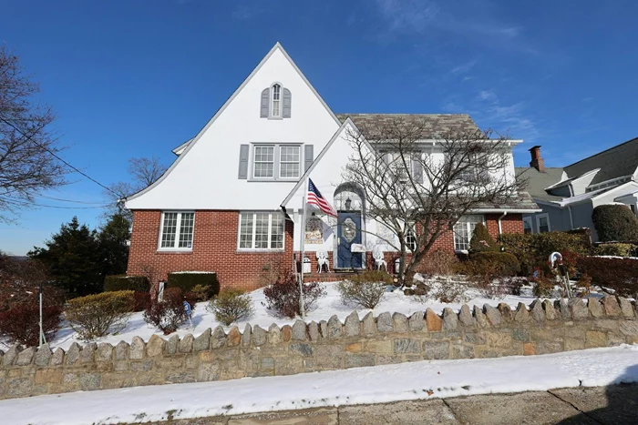 This stunning 1925 Tudor-style home offers historic charm, character and Hudson River views from multiple rooms. Featuring 4 bedrooms, 3.5 bathrooms, this home is a rare gem in a wonderful neighborhood.Step inside the inviting entryway to a foyer featuring original hardwood floors, arched openings and French doors to the living room and dining room. Anchoring the spacious living room is a wood burning fireplace with mantle. French doors open to a sun-drenched sitting area, perfect for enjoying the scenic river views. The formal dining room provides ample space to gather with family or friends and is steps from the kitchen and covered porch leading to the flagstone patio outside. Upstairs, the primary suite offers a private retreat with river views, a sitting area, dressing area and an ensuite bath. Past the full bathroom in the hallway, three additional bedrooms provide generous space, one of which has a full ensuite bathroom to itself. A staircase then leads you up to the third floor to find two additional bonus rooms ready for whatever life requires - an office, studio, exercise room, game room, media room - the possibilities are endless!Outside, a landscaped yard with stone walls covered in ivy and a flagstone patio invite relaxation or entertaining. The driveway allows for ample off-street parking, plus there&rsquo;s a one-car garage accessed from the back of the house. Conveniently located near shops, dining, and commuter options, this storybook home is a must-see. Schedule your private showing today!