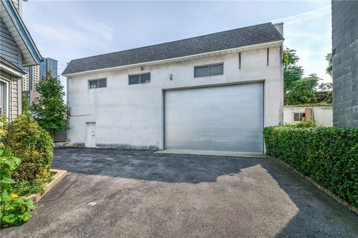 Rent these true oversized garages for two commercial vehicles plus driveway parking. Nothing spared, well thought out, high 25 ft ceilings, half bath, heated, separate second floor office space with built-in desk, a/c and heat, alarm, great storage space. Zoned Light industrial