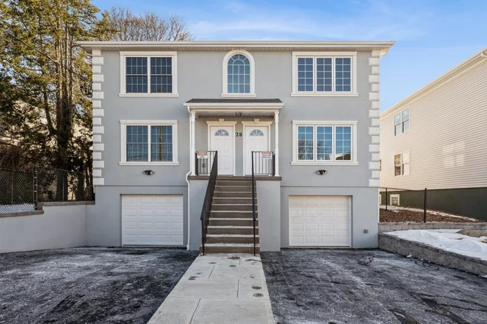 Step into this fabulous newly constructed 2-family home which can perfectly blend the needs of homeowners, multigenerational living, and investment potential. Each unit features its own private entrance, opening into a spacious, open layout filled with natural light. The bright, modern kitchens are equipped with energy-efficient stainless-steel appliances, quartz countertops with large islands, creating a seamless flow for entertaining, meal prep and dining. A sliding glass door off the kitchen lead to a large deck which allows for private outdoor living. Both units have primary bedrooms suites which include walk-in showers and large closets, and two additional well-sized bedrooms with closets and a full hall bath. Convenient washer/dryer hookups are located in each unit. The fully finished walkout lower level with two additional bedrooms with closets and a full bath is accessible via a private entrance on the right side of the home and adds more value. Parking is a breeze with two garages and additional off-street parking for up to four cars in the driveways. The home is thoughtfully designed with separate utilities, hardwood floors throughout, and central air for maximum comfort and privacy. Located in a well-established neighborhood with easy access to main roads, major highways, shopping, public transportation, and a nearby playground, this home offers a unique combination of convenience and functionality. Come tour and discover the potential!