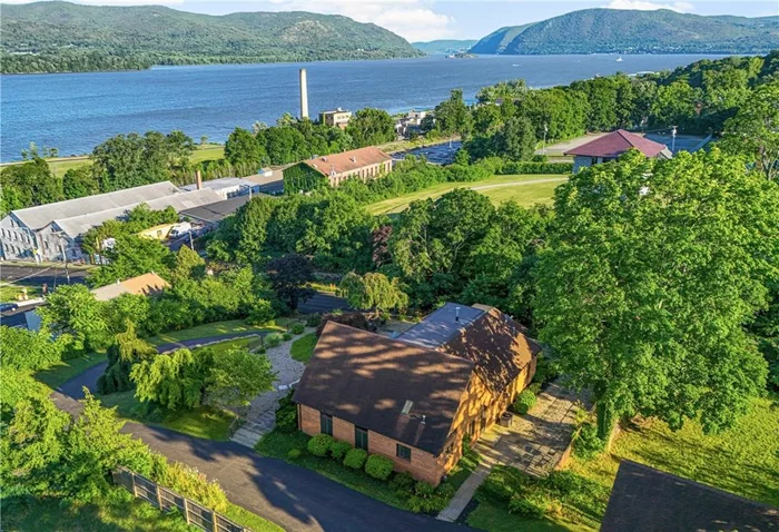 COMMANDING position in Newburgh on a promontory overlooking the Hudson River with unparalleled views up and down the River all the way to Bannerman&rsquo;s Island! Directly adjacent to historic Washington&rsquo;s Headquarters sits this handsome single level solid, well-built custom home. There is a separate two story building behind with a 2 car garage and a 1 bed apt above on the second floor- all this sitting on almost 3/4 acre for privacy! Property class is listed as &rsquo;multiple residences&rsquo;, not multifamily. The house is a dream property for single level easy open plan living with a great flow and layout. There is a massive full height attic space (look at that roof pitch!) that has the potential to be developed further for another level. Similarly, the second building with the garages and apt above has a huge attic space that also has potential for further development. This impeccably maintained property has been updated with Central Air and an energy efficient Navien Combi-Boiler for hot water/heat in the main house which has cast iron baseboards( the best!) . The property faces due east so you awaken to beautiful sun rises across the river and in the evening you can watch magical moon rises. And then in Fall, you are treated to the most spectacular sunset views of the foliage on the mountains across the river turning brilliant orange as the seasons change. This is truly a unique property with unsurpassed views and further potential! It also appears to be the only privately owned property in the Waterfront Gateway Zoning which allows multi story development if you chose to develop it further.