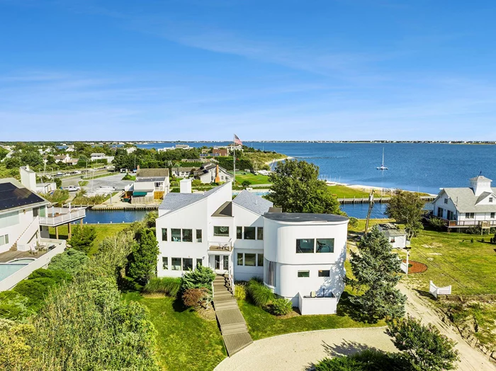 Completely renovated in 2017, this immaculate contemporary is the perfect vacation spot, complete with water views from nearly every window. With approximately 3, 400 SF of interior space, this architectural wonder features 6 bedrooms, including a junior master on the first level, 5.5 baths, a semi-detached cabana with a sitting room and bathroom, an in-home gym with 5 person marble spa/steam room with ambient lighting and Bluetooth sound system, upstairs and downstairs living rooms, billiard table, 2 fireplaces, flat screen TVs, Sonos system, and so much more. Enjoy the views of the open bay from the upstairs master balcony, the upstairs living room balcony, or the 3, 000 SF deck off the lower level, complete with a heated pool and hot tub. Ability to dock a boat (not included), jetski (not included), or paddle board, and more from your backyard. Private Stokes Lane bay beach completes this ideal summer getaway. *Dock is not included in the rental, but is available for an additional fee. Availbale July $29K, August - LD $34K, and Memorial Day to Labor Day $80K. Rental Registration #RP241125