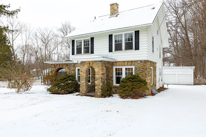 Tucked away and set back from the road on over an acre of level property, this well-maintained stone Colonial offers timeless charm and comfortable living. A horseshoe driveway leads to this inviting home, where original details like wood trim, solid wood doors, a stone fireplace, and white oak floors with mahogany inlay add to its character. A screened porch overlooks the yard, making it a perfect spot to relax or enjoy summer evenings. Upstairs, you&rsquo;ll find four spacious bedrooms, all filled with natural light and featuring hardwood floors. The open hall ties the space together, and a walk-up third-floor with full daylight windows provides plenty of extra storage. Outside, the yard offers great space for gardening, play, or gatherings. The back patio, swing set, and a detached two-car garage complete the property. The home is located in the Arlington School District in a very convenient area within walking distance to Vassar College, Vassar Farms, and just a short drive to shopping, schools, and major commuter routes.