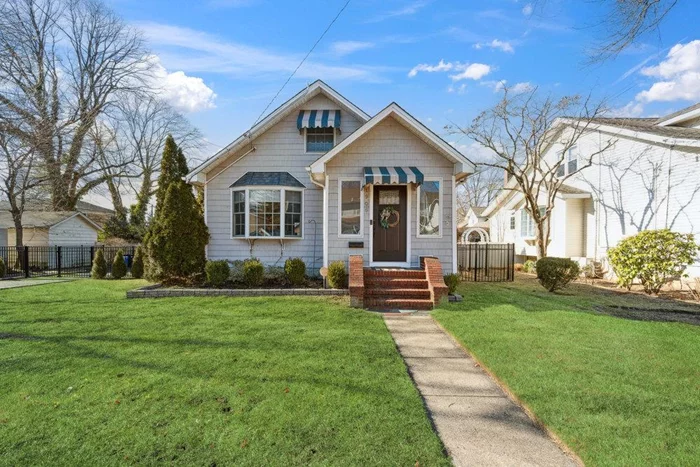 Charming Bungalow with Personality & Style!Home is beautifully updated home was completely renovated in 2004, featuring newer insulation, electrical, sheetrock, cedar-look vinyl siding, roof, and Andersen windows. The first floor boasts an open-concept living space with soaring ceilings and stunning chestnut hardwood floors.The flexible layout allows for a primary bedroom on the first floor or a private ownerâ€™s suite on the second floor, complete with an en-suite bath, walk-in closet, and built-ins. The welcoming entryway doubles as a cozy sitting or reading nook. The bright and airy living room flows seamlessly into the dining area and kitchen, which showcases maple cabinetry, stainless steel appliances, and granite countertops. Home features Central Air Conditioning, Hi-hats & Lease Solar Panels for Electric.The full basement offers direct access from the main floor, making it ideal for furniture and storage. It includes multiple areas for recreation, a home gym, and ample storage space.Outside, the spectacular backyard is designed for relaxation and entertaining, featuring a maintenance-free composite deck, a spacious patio, and plenty of grassy space for play. A private dog run ensures a pet-friendly retreat. The large driveway and oversized two-car garage provide ample parking and storage. The yard is enclosed with a beautiful, high-quality wrought iron fence.Conveniently located near parkways, shops, and schools, this home is a must-see!