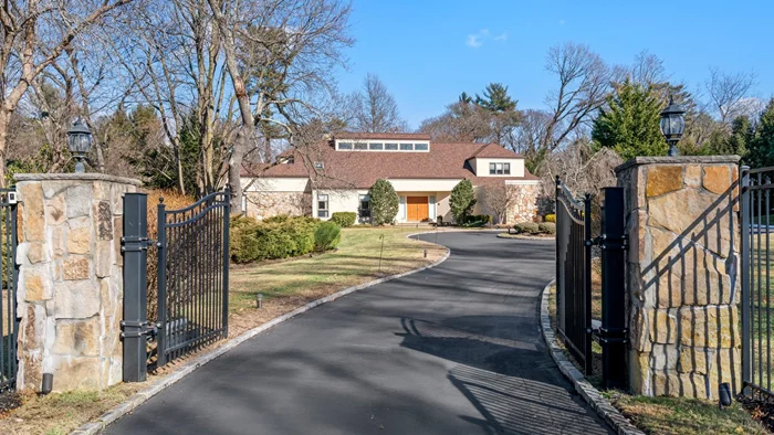 This beautifully gated renovated contemporary home resonates with clarity and light as each and every window takes in the entire expanse of the landscaped. It features a modern design with soaring ceilings, an open floor plan, granite countertops, marble flooring,  and a wood burning fireplace. The spacious living room provides an inviting space for entertaining, enhanced by the warmth of the stone fireplace. For cozy winter nights, a more intimate den offers comfort and relaxation.  The renovated kitchen boasts top appliances, a center island and breakfast nook. There&rsquo;s also a separate bedroom perfectly suited for long term guests or as a home office. The generous primary suite is on the main level and offers offers a dressing room, fitted closets and a luxurious bathroom complete with a tub, shower and two sinks. All of this is set on two beautifully landscaped acres. Recently replaced roof,  boiler, hot water tank and doors. Security System. East Williston Schools.