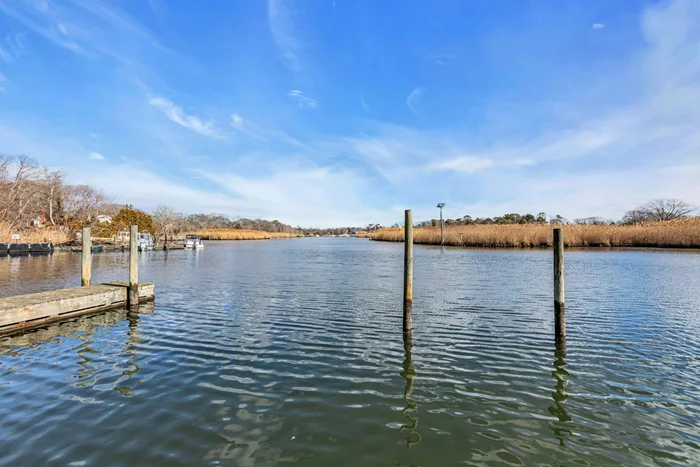 Calling all boaters! Immaculate waterfront home, just outside of the vibrant Village of Patchogue is this sprawling ranch on a quiet dead end street overlooking Swan River. Offering 75&rsquo; bulkhead, 2 docks and 4 boat slips, and just a short boat ride to Patchogue Bay and Fire island. Enjoy water front living with easy access to all water craft activities: from kayaks to canoes, and stand up paddle boards to motorboats! The picturesque setting is visible from either the relaxing expansive deck or inside the home through all the large windows. Inside, the generous sized rooms are quite impressive. The large foyer welcomes you into the bright and opened living room with fireplace and water views. The adjacent spacious kitchen offers counter seating and even more views. The primary suite has a WIC and private full bathroom. A second bedroom is en suite with private bath. The 3rd bedroom, powder room and access to attached garage complete this level. The basement is a large dry space with laundry area, walk in cedar lined closet, powder room, utilities and recreation area. Exempt from flood insurance and not in a flood zone. Don&rsquo;t miss this opportunity.