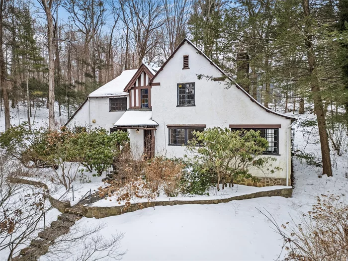 Welcome to this classic stucco tudor, perched hillside on over 1 acre of rolling grounds, steps from downtown Chappaqua. The property boasts rock walls with built in seating, mature landscaping, a cascade, and multiple stone patios for entertaining. It is waiting for the right person to bring it back to its glory, helping to accentuate the coffered ceilings with rope trim, archways and stained-glass windows. Featuring a large eat-in-kitchen and living room with oversized stone fireplace and adjoining den/office space. Belgium block driveway, central A/C and hardwood floors throughout. Located on a private street, it is serene in setting, yet vibrantly located just 0.1 miles from Chappaqua shopping, metro-north train, library, and farmers market. Enjoy all of what Chappaqua and New Castle have to offer- Gedney Park for ice skating and sledding, day camps, senior programs and more!