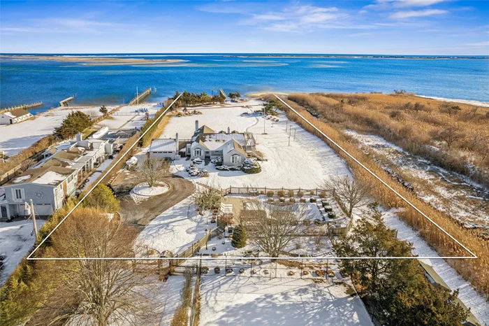 Located at 52 Tuthill Point Road in East Moriches, this waterfront paradise offers blissful views of Moriches Bay. The 2, 080 square foot shingled cottage was renovated in 2021 and is ready for its new owners. Drenched in natural light, the living space offers comfortable areas to lounge, entertain and work from home. The living room with vaulted ceilings and the den have wood burning fireplaces and both offer views of the grounds and the bay beyond. The open kitchen is sleek and white with Carrera marble countertops with room for stools, an Arga induction stove, all new stainless-steel appliances and new composite wood flooring, and a separate dining area as well. Three bedrooms, 3 bathrooms with porcelain tile, marble and touches of stainless steel. The primary bedroom has an en-suite bathroom with radiant heated floors. There&rsquo;s a mudroom, laundry room, and a 2-car garage. Step out onto a large deck and enjoy the endless views of Moriches Bay and the wetlands preserve. Launch your kayak, canoe or paddleboard from your own sandy bay beach, or sail away from your dock. When you return, relax by the heated Gunite pool surrounded by beautifully designed garden areas. 52 Tuthill Point Road is truly a gem.