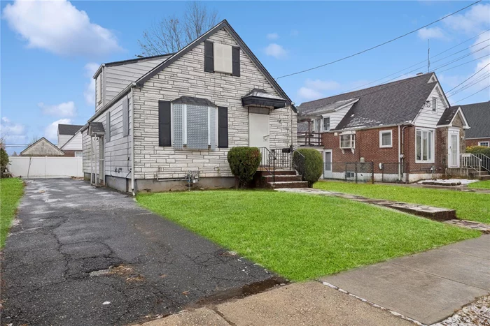 Cape-style home in Hempstead area situated on a generous 50x100 lot. The home boasts an estimated 1, 247 sq ft of interior living sq ft, featuring beautiful hardwood floors throughout. Additional highlights include a basement with outside entry and large driveway.