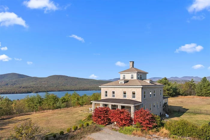 Perched atop a picturesque hill with breathtaking views of the Ashokan Reservoir and Catskill Mountains, Baker Manor is a distinguished estate that embodies both historic grandeur and contemporary comfort. Built in 1918 by J. Waldo Smith, the chief engineer of the Ashokan Reservoir project, this remarkable Neo-Classic stone mansion was masterfully constructed using locally sourced cement blocksâ€”the very same material used in the creation of the Olivebridge Dam. Designed for enduring strength and beauty, the home&rsquo;s exterior walls feature a striking pattern crafted from three distinct molds, a testament to the craftsmanship of its time.This distinguished estate, once home to acclaimed actor Chevy Chase, spans 9.10 picturesque acres, offering unparalleled privacy and room to explore. The grand 3, 500-square-foot residence boasts five bedrooms and three bathrooms, seamlessly blending timeless elegance with modern conveniences. The home&rsquo;s stately faÃ§ade, adorned with majestic columns and an inviting porch, exudes an air of sophistication.Inside, original red oak moldings, hardwood floors, and soaring ceilings create a warm and refined ambiance. The formal living room, anchored by a classic brick fireplace, serves as the heart of the homeâ€”an ideal space for relaxation and entertaining. Oversized windows bathe the interiors in natural light, while French doors open onto a stone patio, where sweeping mountain and reservoir views take center stage.The chef&rsquo;s kitchen is both charming and functional, featuring a farmhouse sink, stainless steel appliances, a spacious island, and abundant cabinetry. It seamlessly flows into the formal dining room, where original pocket doors provide an elegant transition into the living area.The grand staircase leads to a luminous primary suite, a private retreat and ensuite bath. A vintage clawfoot tub, perfectly positioned to capture the stunning views, serves as the focal point. The additional four bedrooms each retain their early 20th-century charm while offering modern comfort.At the pinnacle of the home, the third-floor cupola boasts windows on all sides, offering an awe-inspiring perspective of the surrounding landscape. The carriage house offers exceptional versatility, serving as an ideal guest retreat, rental opportunity, or creative space. Thoughtfully designed with a blend of historic charm and modern updates, this secondary residence enhances the estate&rsquo;s appeal. Many original details have been carefully preserved, while contemporary conveniences ensure comfort and functionality.Step inside to a cozy living room, where a brick fireplace radiates warmth and character. The adjacent dining area, framed by elegant French doors, opens to a whimsical deck, perfect for savoring your morning coffee amidst the peaceful surroundings.The charming kitchen is a delight, featuring a vintage-inspired retro stove, stainless steel appliances, a coffee bar, and a pantry for ample storage. Three well-appointed bedrooms on the main floor each offer a tranquil retreat, blending classic design with modern comfort.Upstairs, a spacious great room provides endless possibilitiesâ€”yoga studio, art space, or additional lounge area.Outside, the expansive landscape is designed for relaxation and enjoyment. Serene patios, a soothing hot tub, and lush greenery create a private oasis, inviting you to unwind and reconnect with nature. A luxurious in-ground saltwater pool is perfectly positioned to take full advantage of the breathtaking mountain views, creating an idyllic space for relaxation.Located just two hours from New York City, Baker Manor offers the perfect balance of privacy and accessibility. From fine dining and cultural attractions to hiking, skiing, and outdoor adventures, the best of the Catskills is just minutes away.Baker Manor is more than a homeâ€”it&rsquo;s a legacy. Experience the unparalleled beauty and history of this once-in-a-lifetime Catskills estate.