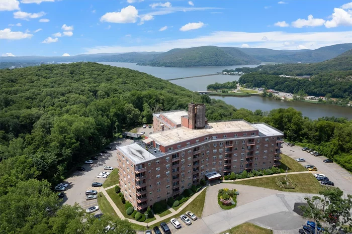 Luxury Living with Breathtaking Hudson River & Mountain Views!Welcome home to this stunning 3rd-floor corner unit in the highly sought-after Peekskill Towers, offering spectacular year-round views of the Hudson River and mountains from every western-facing window.Step inside to find a gorgeous, sun-drenched living and dining area, freshly painted and featuring rich cherry wood floors. The open-concept dining and living room create a bright, airy space, perfect for entertaining or relaxing. A covered private balcony extends your living space, accessible through sliding glass doors.The updated kitchen flows seamlessly into both rooms, making mealtime and hosting effortless. It shines with wood cabinetry, stainless steel appliances, granite countertops, a tiled backsplash, and an island perfect for meal prep and gathering. A stylish open archway enhances the connection to the spacious dining room.The oversized primary suite boasts two spacious closets and an en-suite full bath with updated tile floors and a tiled shower. The second bedroom is equally bright and airy, with easy access to the additional completely updated full bath.Storage is no issue here, with two oversized closets in the living roomâ€”one featuring floor-to-ceiling mirrors and the other with pantry shelving. Wall air conditioning units keep the home comfortable year-round.Enjoy fantastic development amenities, including a sparkling outdoor pool (visible right from your living room window!), two assigned parking spaces, shared storage space, and a same-floor laundry room just steps from your door. The well-maintained, secure building features two elevators and a community room for added convenience.Located just minutes from the Metro-North Peekskill train station and near the heart of Peekskillâ€™s vibrant arts community, you&rsquo;ll have endless dining, shopping, and entertainment options at your fingertipsâ€”including the renowned Paramount Hudson Valley Theater.Come see it for yourselfâ€¦ your new home awaits!