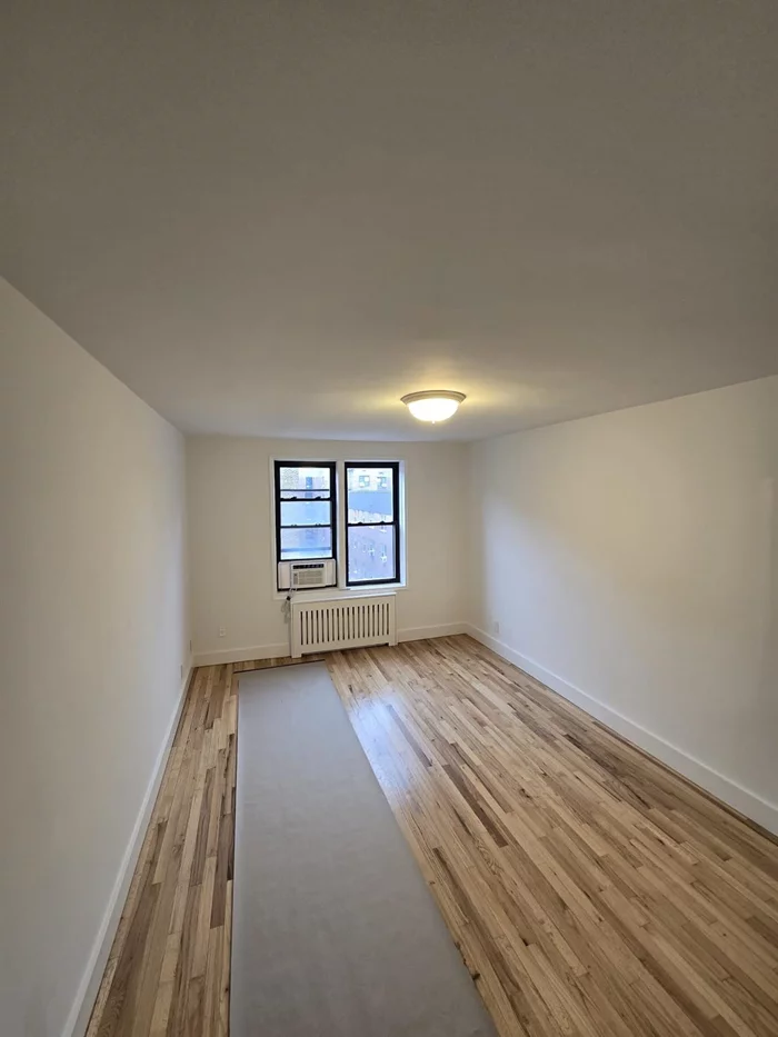 Welcome Home! Location Location Location! Bright, Sunny, Large King Size 1 Bedroom 2 Blocks from 63rd Street Train Station: 30 Minutes to Manhattan. Real Hardwood Floors Throughout, Windows in Every Room Including Bathroom and Kitchen. Marble Kitchen Countertops with Stainless Steel Appliances. Low Common Charges and Real Estate Taxes. Great for Investment or Starter Home. Laundry Room in Basement and Indoor Parking Available with Wait List.