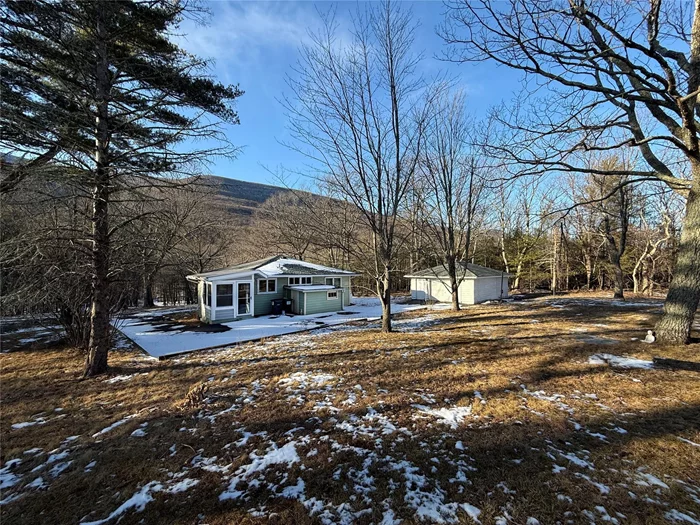 Make this sunny 2 bedroom cottage your home! The house is perched on a cliff with sweeping views of the Kaaterskill Wild Forest. A freshly renovated kitchen and bathroom, single car garage, on-site laundry, and plenty of closets make every day life easier. The kitchen provides ample cabinets, marble countertops and backsplash and new dish washer, gas stove, and refrigerator. Thereâ€™s an impressive mountain view from both the living room and sun room. There is a sweet little bathtub with an overhead shower, and ceramic tile floor in the bathroom. A new filtration system provides high quality drinking water from the tap. Both bedrooms have closets and sturdy, high quality blinds. For extra coziness, use the Jotul propane stove in the living room! Hardwood floors throughout. Tenant pays for gas and electricity. Landlord provides snow removal and lawn maintenance. Offering 6 or 12 month lease options.