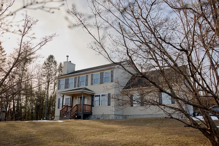 Set back from the road, down a long, shared driveway, this move-in ready colonial offers comfort and convenience in a pretty setting. Built in 2006, the home is nicely sited on 2 acres, overlooking the gently sloped front yard with its mowed trails and habitat-friendly shrubs. A mature stand of evergreen trees planted along the road provides a nice screen. In the backyard is a firepit area as well as a solar array to harness natural energy. The half-bath/laundry room is conveniently located off the entry hall from the two-car garage. You&rsquo;ll find hardwood floors throughout the kitchen, sunny dining area, cozy living room with fireplace, and formal dining room/study. Generously sized windows let in the sunshine in the front facing rooms, while the full glass slider opens to the back deck and the window over the kitchen sink has a woodsy backyard view. Upstairs, the primary bedroom offers large windows, 2 closets (including a walk-in), and a beautiful ensuite with a soaking tub, walk-in shower and skylight. Down the hall are 2 additional bedrooms, another full bathroom, and a spacious bonus room! Central air keeps the home cool and comfortable in the summer months. There&rsquo;s tons of extra space to hang in the freshly painted basement, which has its own mini-split unit for heating and cooling. This home checks so many boxes, all that&rsquo;s left to do is make it home. Call to book a showing today!