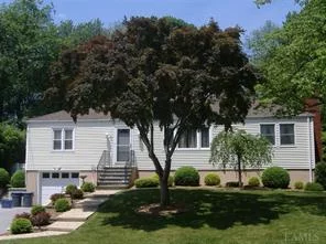 Curb Appeal! Vinyl sided 3 bedroom ranch with hardwood floors, central air, kitchen with breakfast bar, brick wood burning fireplace and large family room with woodburning stove. Unilock driveway, 1 car garage, front yard lawn sprinklers and beautiful fenced backyard with unilock patio and 16x32 inground pool. Just move in and enjoy!