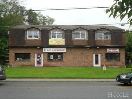 HIGH VISIBILITY location with great exposure on Rt 6. Great opportunity for an owner/user or investor to purchase this freestanding two-level building with 4 rentals + storage - 2 storefronts facing Route 6, a large second floor office or business, 3-room office/storage space, and large 2-bay garage in rear of property; great for landscaper/contractor. Parking for 20+/- cars. Tremendous potential for improvement and increased rent roll (Annual rental income is projected/based on market rents.)
