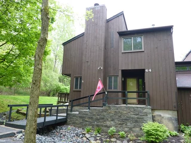 This well-maintained, just professionally painted, updated 3 level unit offers a unique country setting in a natural wooded environment. Upgrades: windows, Andersen French door sliders, furnace, A/C, hot water heater, bathrooms, kitchen, carpets, appliances, washer/dryer, 6 panelled doors (on 1st floor). Hardwood floors in liv/din rooms,  tile throughout balance of 1st floor. Wood burning fireplace with custom mantel. Very private deck & backyard. Front entrance is one of the most appealing in the complex with bridge & paver walkway to front porch with shade trees. Community pool & tennis. Woodbury recreation. Commuter bus stop to NYC at entrance to complex, close to train, Thruway, Woodbury Commons, West Point. AHS Basic Home Warranty included for 1 year after closing. Buyer Incentive of 1st year of HOA dues in the amount of $3120.00 to be paid at closing.