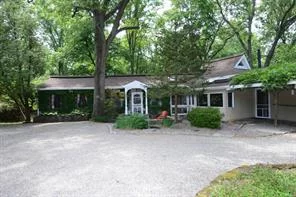 This charming home has it&rsquo;s own lakefront property. Original 1938 stone home with additions and renovations in 1983. Many updates since then. Enter into an open living room and dining room with walls of glass overlooking wooded property. Wrap around two tier decking great for entertaining. Master bedroom on first level with renovated master bath w/steam shower.  Great work kitchen with newer windows overlooking wooded area. Oak butler&rsquo;s pantry for extra storage. Lower level lends itself to guest quarters or in home office. Separate entrance from lower level. Studio stone cottage with full bath on property with electricity and water. Great storage in large walk in cedar closet, clean space storage in hall on lower level. Storage garden shed and additional two storage spaces on lower level decking. Separate stone studio cottage. Walk down to private lake front property on community lake association.