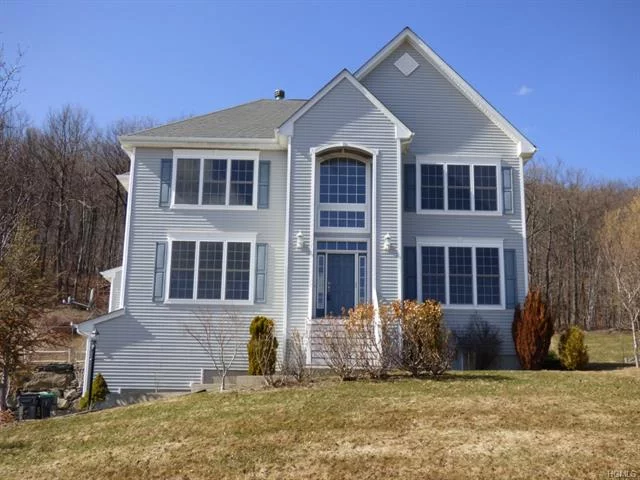 Breathtaking mountain views from this beautiful contemporary colonial. Brand new gleaming oak hardwood floors just installed. Whole house freshly painted. Grand entrance way is a must see. Granite counter tops in this large eat in kitchen. Relax in this amazing family room that has a fireplace and huge windows. Central air and an additional fan to circulate airflow throughout home. Master suite has three closets and vaulted ceilings. There is a large additional room on the main level that can be an office or playroom. One acre of property for back yard BBQ&rsquo;s. Two car garage has high quality insulated garage doors. Close to main highways and shopping. Monroe-Woodbury School District. Enjoy The Rez nearby. www.woodburyparkandrec.com