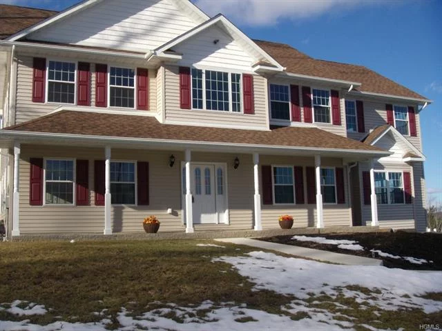 This custom colonial is up and ready. There is a two story entry with a sweeping oak and wrought iron staircase that leads you to a floor plan that is open and bright. The huge family room has walls of windows,  a gas fireplace and spectacular Mountain views. The kitchen has a large island, walls of cabinetry and s/s appliances. Granite counter tops are in the kitchen and all baths. The Master bedroom has a tray ceiling, his/her walk in closets, and a bath with double sinks, whirlpool and tiled shower. All the tiles are imported and all the floors are wide board select oak. There is a first floor bedroom/office/playroom. The builder installed a flat screen TV in wall prep.in nearly every room. The walkout basement leads to a beautiful level backyard perfect for fun and entertaining. This is a gated community. The HOA fees are $98.00 since the club house is not completed. When finished the HOA fees will be approx $180.00 per month. This community is 5 min to the Woodbury Commons.