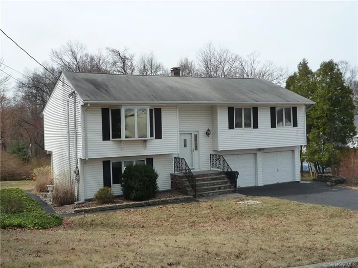 This expanded Bi-level is located in a great commuter location with a level private yard and pool with patio for entertaining. There are hardwood floors through out the upstairs. The kitchen and dining room have been expanded for a large family use and an additional enclosed insulated sun room can be used year round if you choose. There are three bedrooms and a updated full sunlite bathroom with skylite on the main level. The lower level has a fourth bedroom and family room plus a half bathroom that can be expanded to be a full bathroom. The lower level also has a boiler/laundry room and a two car garage. Yard has sprinkler system.