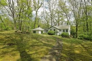 Whimsical wonder. Old world charm meets theatrical splendor. The sunken great room with a massive stone fireplace, rich hardwood floors and gorgeous natural light is the centerpiece of the cottage. The adjoining pool room creates an entertainers delight. This cozy gem is set on a winding road with grounds to inspire as well. With a little love, this is a perfect weekend getaway or year round retreat.