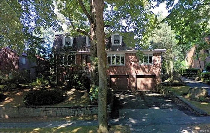 This is a large brick colonial with beautiful grounds located in the Fieldston historic district. 3, 750 sf plus a full finished basement and oversize 2-car garage. The living room is spacious with a fireplace and a large picture window overlooking the landscaped rear yard. There is an over-size eat-in kitchen with high-end appliances, and a separate laundry room that includes a freezer. There are 2 full baths on the upper floor and, for convenience, a half-bath on the first floor and basement as well as a central vacuum system. There is a very large flagstone patio and the sidewalk is done in matching flagstone. All floors are hardwood or ceramic tile, including the basement. Much of the floors have been covered with wall-to-wall carpeting since the home was built. The basement is fully finished with a ceramic tile floor and areas for storage and play, as well as a built-in bar. Fieldston is located conveniently for access to Manhattan and Westchester.