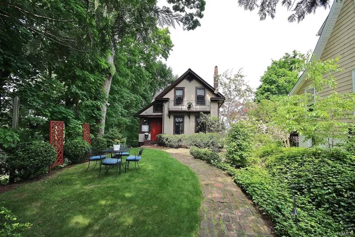 If you are looking for a charming, vintage Tudor, look no further. This well preserved home exudes character and has many interesting architectural details and updates while maintaining its integrity. Enjoy the updated kitchen, along with the vintage oven, brick fireplace in the living room and formal dining room with wonderful woodwork. Beautiful stained glass windows. The fenced-in property provides an oasis with wonderful deck and lush landscaping. Updated bath, roof, gutters, electrical service and plumbing. Newly painted exterior. This is not a cookie cutter home!