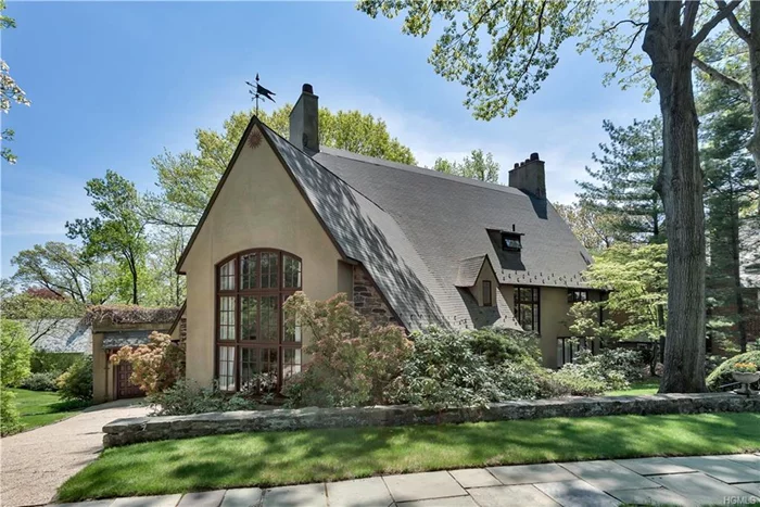 This 1915 stone and stucco 8 BR Tudor Revival home is located 25 min from Manhattan in the Historical Fieldston area of Riverdale. THE PROPERTY INCLUDES AN EXTRA DEEDED AND DEVELOPABLE LOT. Mayor La Guardia lived in the house from 1945 to 1947. On the first floor both the elegant Living room and the Library have wood-burning fireplaces, the formal dining room features beautiful garden views, the heated sunroom , and the kitchen includes an eat-in area and butler&rsquo;s pantry. The large master bedroom with the fireplace overlooks the gardens and greenery from the second floor which also features 4 additional bedrooms, 2 baths and large Terrace off one of the bedrooms. The third floor offers 3 bedrooms, 1.5 bt and large cedar closet. There is a finished attic and a finished basement with laundry room, 2 additional rooms and 1 bath, The 2 car garage .The extensive grounds and two patios complete this unique and beautiful home. Centrally located within 5 min walk to private schools.