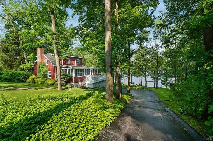 WATERFRONT WITH DOCK! Filled with charm and character this hip, renovated lakefront home has it all. Sited perfectly this classic cottage evokes memories of an Adirondack Lake House yet with a modern twist. Enter from the side deck to your enclosed porch with exposed rafters and pine panelling. Be drawn in by the sunny living room with massive beams, w/b/f/p, random width floors, panelled walls and adjoining full bath. The renovated kitchen has leathered granite counters, stainless appliances and lovely water views. The family/dining room captures views of the lake with wall to wall windows. Upstairs are 2 charming bedrooms, den/office, and full bath, lives like a 3 b/r. Updates include custom cabinetry, plumbing, roof, drainage, refinished floors, generator hookup. The oversized dock was built by BD Dock Systems with stainless steel anchors. The lakefront is completely bulk headed for easy water access or sit by the stone fire pit and gaze out onto Lake Truesdale! Low Taxes!
