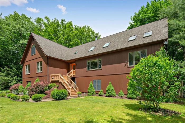 Give grandma & grandpa their own suite! A family haven on 5+ private acres just a short drive to the Taconic state parkway or Metro-North. Not everyone gets to have the convenience of an easy commute, close to shopping & schools, total privacy but in a neighborhood at the same time. A truely unique opportunity. Soaring ceilings & skylights create bright , airy spaces! Enjoy an extra large kitchen with new granite counter tops, beautifully renovated cabinetry, tiled flooring & new SS appliances. Off the kitchen is a cozy sitting room with a wood burning fireplace. Generous size bedrooms = Four plus a den. The master en-suite also accesses the deck. The main level leads to a beautiful hideaway on the third floor; could be a reading nook, man cave, a she suite or a play room. The lower level features a magnificent new kitchen with a breakfast bar, a formal dining room, living room bedroom, den, full bath and enjoys a separate patio in back. Private laundry areas for each. MSTA!