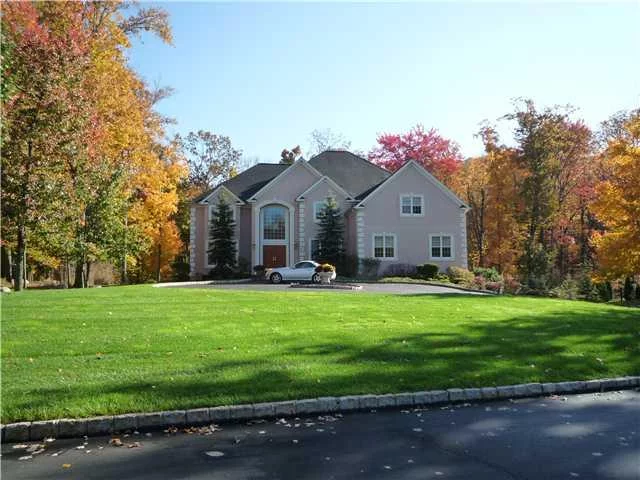 This prestigious stucco home in the Greens of Woodbury offers over 7000 sq ft of luxurious living space. Two story entry w/ split staircase, hard wood floors w/ inlays, Gourmet kitchen w/ GE monogram apl, Two story bright airy great room with gas fireplace overlooking the cedar deck w/ hot tub on this private lot backing up to the golf course. In law suite for extended fam. Second floor offers a master suite to pamper yourself w/ sitting area incl fireplace, luxurious mastr bath w/ Jacuzzi tub, walk in closet w built ins, three other large bedrooms each w/ separate fully tiled bathrooms, Walk out finished basement w/ fireplace and a heated three car garage, Everything is in pristine condition.