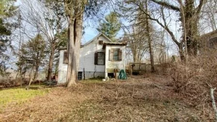 Summer cottage ready to be renovated and brought back to life. Situated on wooded .28 acre and close to everything. Community pool, clubhouse and playground (reasonable annual dues). Neighboring cottage at 111 Redwood St., in similar condition, is also available. Package deal for both is an option.