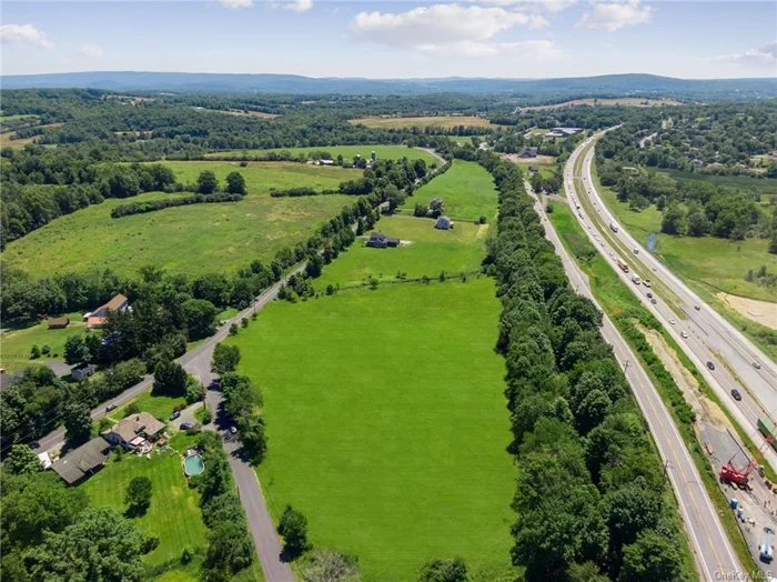 Looking east toward Woodbury Common Premium Outlets, The Castle Fun Center and Driving Range, West Point, Palisades Interstate Park and Bear Mountain, Monroe and Harriman, and I-87 (to New York Stewart International Airport, Albany, NYC).