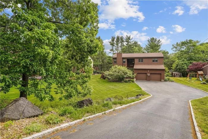 A great place to call home! This lovely 4 level contemporary colonial is sun filled with vaulted ceilings and skylights. The granite tiled entry foyer leads you to the oversized formal living room with fireplace. Hardwood floors in living room newly refinished. There are hardwood floors on 3 levels. You will find another fireplace in the family room with sliders to the large Trex deck and is also open to the kitchen. Enjoy meals in your formal dining room, also with sliders to the back deck. The layout makes it a breeze to entertain all your family and friends. The upper level features a master bedroom with walk-in-closet and master bath. Three other generous bedrooms and bath complete this level. The lower level with new flooring also offers great flexible space-it can be used as additional entertaining space, a playroom or office, your choice! Enjoy the outdoors on the beautiful deck, lower bluestone patio and level yard. Short drive to Metro-North, highways, schools and shops.