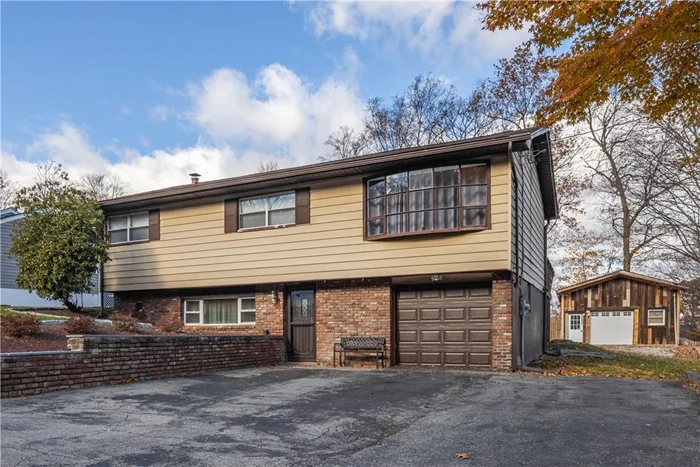 This lovely split level home will charm you with its lovely kitchen, sunny living spaces and hardwood floors. The living room boasts an amazing bay window making it a great space to relax and enjoy your new home. The dining/living room has sliding doors to the deck which boasts built-in seating and is perfect for entertaining family and friends. The spacious lower level has a large entryway and houses the family room, laundry room and still has room for a home office or two. Mud room from garage has huge hall closet to corral your coats and sports gear. This home has town water and town sewer and is close to shopping, Metro North and major highways. The Workshop, designed for the car enthusiast is a dreamy 640 Sq Ft. Make it your private Space for a Yoga Studio or Home Office- Make your imagination run wild.