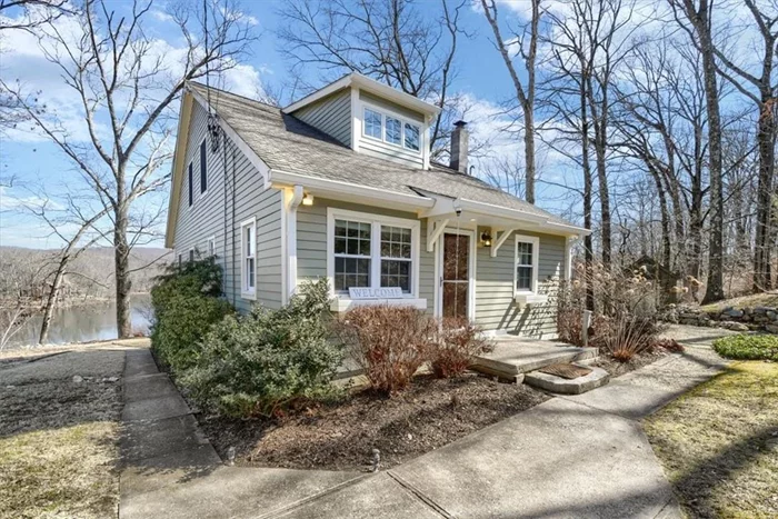 LAKEFRONT LIVING! Absolutely incredibe lake views and direct lake frontage on West Chester Lake (Wallace Pond). Thoughtfully updated & expanded, with a seamless blend of 1960&rsquo;s lake cottage and a 2007 contemporary addition. Open concept living/dining includes cathedral ceilings & wall of windows overlooking the lake. The upper level Primary suite includes a fabulous loft, dressing room/walk-in closet & spa bath w/ soaking tub. 2 additional Bedrooms + a den are located on the main level. Hardwood floors, cathedral ceilings, skylights, ceiling fans, deck and patio complete the lake allure. Lower level is walk out and unfinished w/ plenty of storage - bring your imagination. A perfect weekender or enjoy year round lake living. Updates include hardiplank exterior, roof, electric, heat, restored well pump/house and more.  Close to Route 9, Metro North and minutes to charming Cold Spring Village. Taxes do not include BASIC STAR discount of $1968.