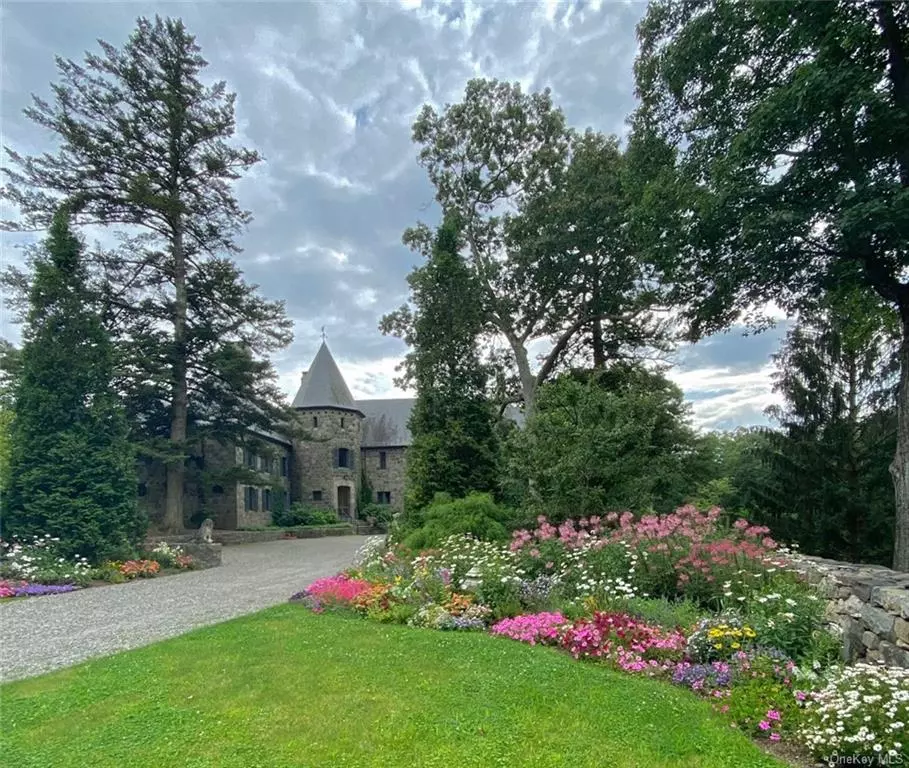 Privately situated in the prestigious riverfront community of Garrison, a graceful driveway, stately trees, and rambling stonewalls lead you to a Hudson Valley Stone Chateaux and Carriage House. Built in the late 1920&rsquo;s and never completed, it has been meticulously restored by the finest craftsmen to her intended charm and elegance. This stunning hilltop oasis sets on 55 acres of natural beauty defined by gardens, undeveloped woodlands, and a meadow. The main Residence, surrounded by perennial, annual, and formal rose gardens, has French doors that flood the spacious interior with natural light, enhancing the approximate 6250 square feet of living space. The ADA access Carriage House has 5 Bedrooms, 5.5 Baths, kitchen, Dining/Living room, Artist Studio, two car garage. This one-of-a-kind chateaux property provides a private setting for peaceful escape, private retreats or a year-round family compound.
