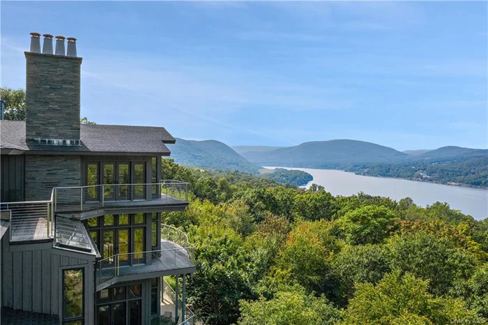This exceptional Contemporary residence of wood and stone is brilliantly-designed combining a bird&rsquo;s eye setting overlooking the Hudson River with an exceptionally-appointed, light-filled floor plan creating a spectacular retreat for today&rsquo;s new lifestyle. Completely private and set on three levels, nearly every room features walls of glass opening to length-of-the-house terraces that watch-over the ever-changing River. Adding to the unique architectural allure are repurposed artifact appointments, including ancient Chinese doors, a turn-of-the-century circular iron staircase, and richly-patinaed copper wainscoting. Finish with home amenities that include a lower level recreation room, indoor lap pool, lounging room with shower and dry sauna, a crow&rsquo;s nest that&rsquo;s the perfect work-from-home private office, and an elevator to every level, you&rsquo;ll never want to leave. A spacious bespoke kitchen with center island is complemented a length of the room breakfast area and ready for relaxing gatherings; and a first-floor master suite with media-fitted fireplace has a luxurious bath with step-in shower, a spa-tub and dual custom-fitted dressing closets. The upper level is perfect for extended family or guests and featuring a spacious sitting room complemented with two guest suites, both with spa-quality baths. Unmatched in style and design, this residence is only minutes to every Garrison convenience and all the year-round outdoor recreational amenities of the Hudson Valley.