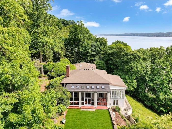 Moon River, a significant, early 20th century home in Snedens Landing, a historic district, 25 minutes from NYC. Approaching the home, one feels relaxed, passing by many 18th and 19th century homes, before turning onto Corbett Lane, a private passageway, with a dense, natural hillside on the west side of the road, and only three other homes on the east side, providing complete privacy.  This home is situated on a bluff overlooking the Hudson River, and features a private, sandy beach and a beautiful meadow with a windy trail between the house and water. Moon River, is a destination. A waterfront lifestyle. Architecturally, the home is significant with an extraordinary great room, with 16 ft ceilings, grand moldings, five 10ft French doors, classic hardware, antique, wide board paneling, beamed ceiling and two period fireplace mantels in the home. Off the great room is a very large screened in porch, also with 16ft ceilings with 8 skylines facing south, that keeps the room sunny all day. There&rsquo;s a very large, solarium, with windows on three sides, that faces the Hudson River, and features classic, Mediterranean tiles floor. The home&rsquo;s stairwell features thick, solid, cedar stair treads, carved from trees that grow on the property, and old-style balustrades, from a bygone era. There are two primary bedroom suites, each with fireplaces, and one with a private den; separate, staff quarters, with private entrance, another en suite bedroom, plus an oversized 2 car garage.  The home was built by legendary artist/resident, Mary Lawrence Tonetti, and designed by renowned architect, Eric Gugler, commissioned in America and Europe, and hired by FDR to redesign the oval office in the 1930s. The home was built for the Lowndes family. Moon River signifies the first night there&rsquo;s a full moon on the Hudson, after the forsythia bloom, where according to legend, the shads run plentiful in the Hudson, and fisherman set their nets, supported by long poles, in the river to catch them. This tradition was practiced at this property for many years, as the original owner recalls in one of the many books written about this fairytale place, once called Brigadoon, by The NY Times. The property also features an inground pool with a pergola with another screened-in porch overlooking the river and pool, and an oversized garage with a large gravel parking parking area. Corbett Lane is not a thru street. Snedens Landing is a neighborhood, and part of Palisades, NY. It is surrounded by a 500+ acre park on the North end, and a 2, 500 acre park on the south side, and the Hudson River on the east side. There are numerous walking trails from any home. The charming, historic riverfront village of Piermont, with many restaurants,  shops and marinas, is only 5 minutes away. The Snedens Landing Tennis Association, tennis court, is open for residents only, for a small fee.  Nothing compares.