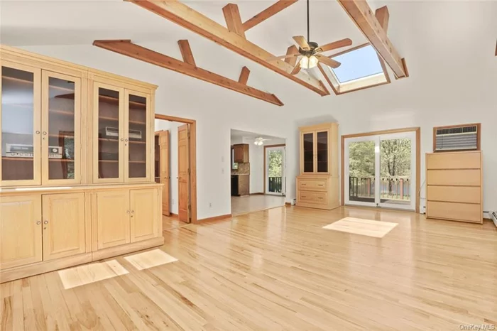 Great Family Room with custom built in cabinetry and glass doors out to deck