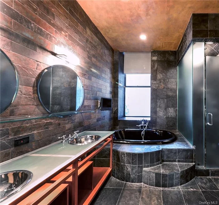 Primary bath with double sinks a soaking tub and rain shower