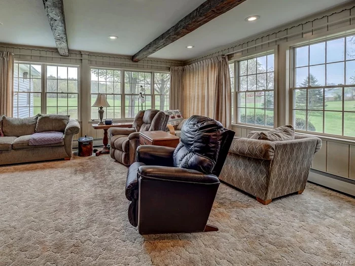 Everyone will love hanging out in this large great room. Walls of windows just let all of the sunlight in.