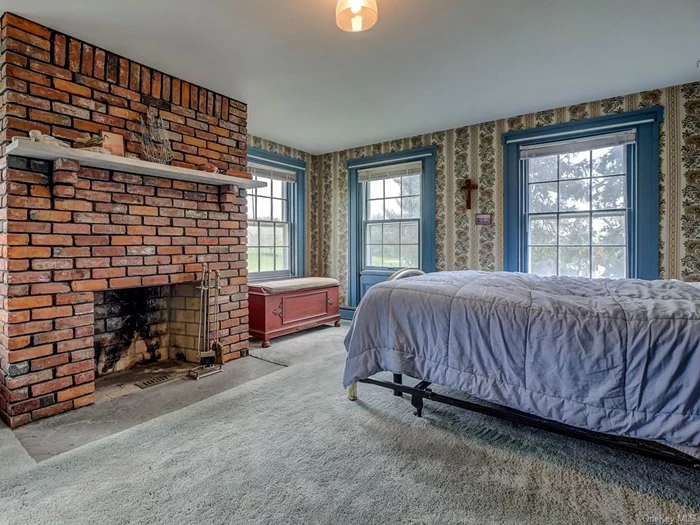 Full brick working fireplace in spacious master bedroom. Note all of the natural light from large windows, to once again enjoy the gorgeous views.