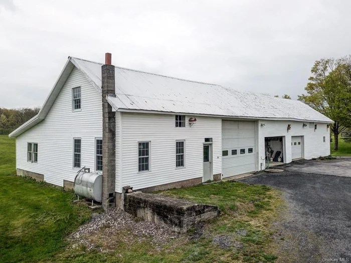 45’ X 90’ barn with oversized garage bays, storage areas, barn area and walkup attic