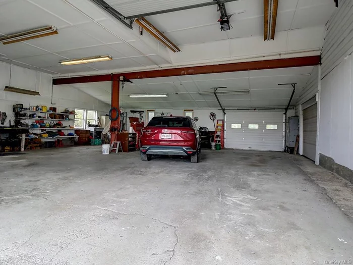 Oversized garage has electricity and workshop area. Perfect for a car buff, carpenter and more.