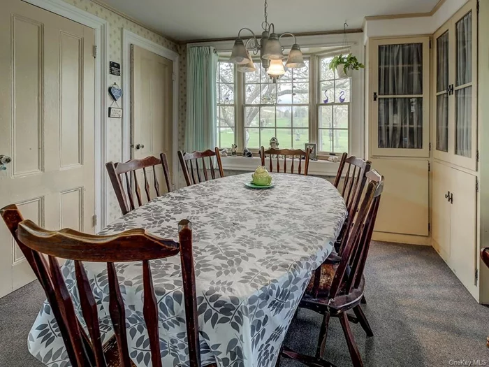 Light filled Country kitchen features built in china cabinets, and 2 pantries. Note the original glass doorknobs and once again, beautiful property views.