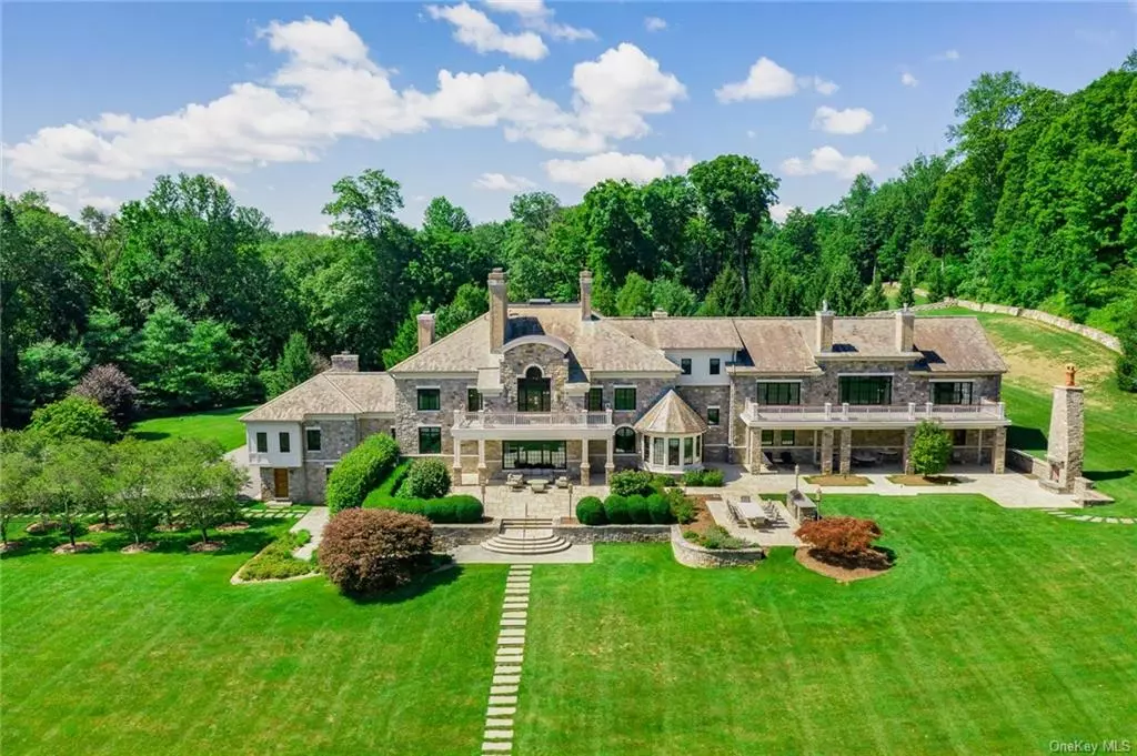Spectacular stone manor house set upon 20 acres of stunning land. Inspired by the great European estates, the home is introduced by a 1, 200 foot drive through an allee of English oak and pear trees. Vast lawns stretch to the edge of a sparking two acre lake that is fed by a rushing waterfall. Completed in 2004, the fieldstone manor comprises 6 bedrooms, 12 bathrooms, and over 12, 000 square feet. The formal entry is centered on a dramatic floating staircase. Beautifully scaled living and dining rooms flank the main hallway. A chef&rsquo;s kitchen is adjacent to a family room with a 20 foot ceiling. An interior hallway leads to a paneled library, home office and first floor guest suite. The sprawling lower level includes, bar, gym, theatre, wine cellar, and indoor basketball court. A separate drive leads to a pool and tennis complex. The ultimate in luxury with garaging for six cars.
