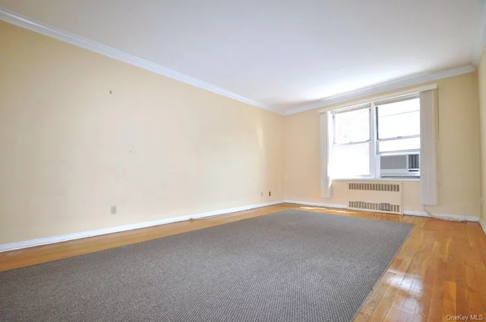 Large Living Room with hardwood floors opens to to the dining foyer.