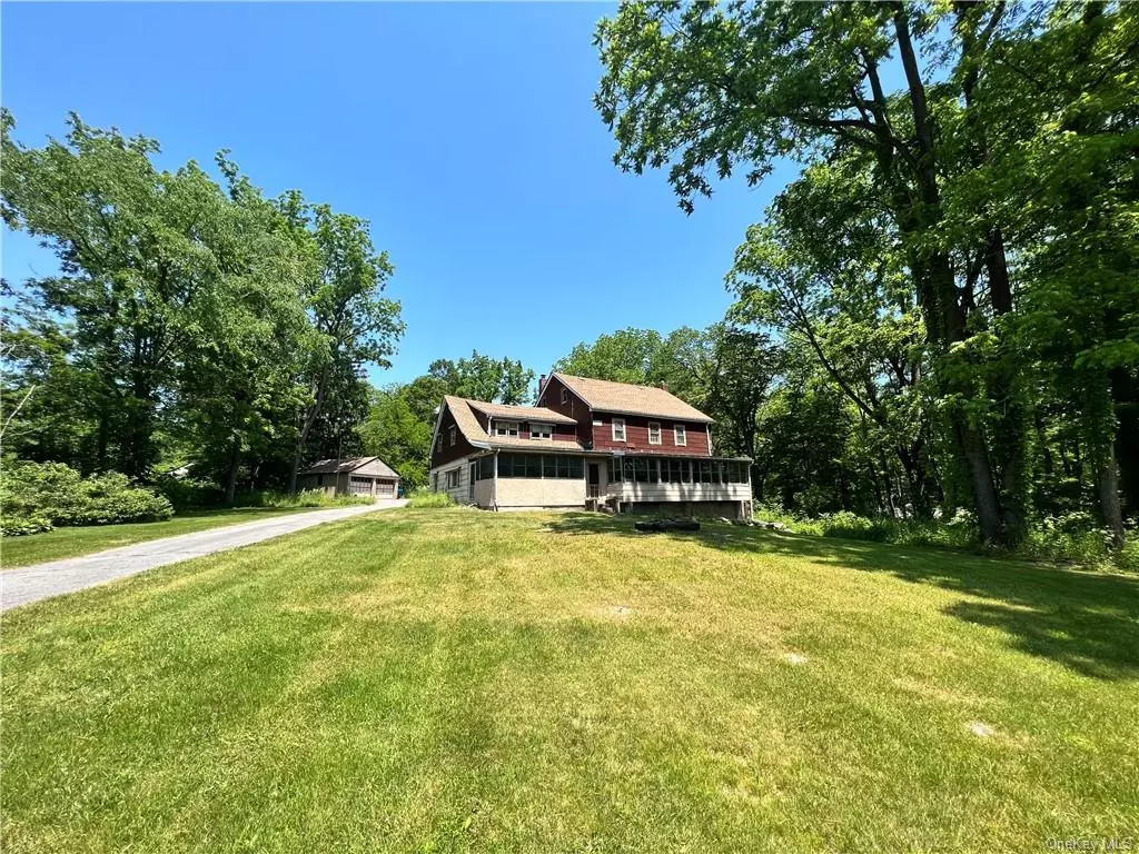 LARGE TWO STORY HOME AND COTTAGE ON FIVE ACRES/WALLKILL SCHOOLS - Looking for a project? This is the one! With the possibility of sub-division, this large parcel with home, cottage and two car detached garage with electric is perfect for someone with a vision. The main home features a kitchen, gigantic dining room, living room with wood beams, full bathroom with walk-in shower, main level bedroom and two front porches. Upstairs has five more bedrooms, another full bathroom, kitchen and a walk-up attic with tons of storage. Tons of Old World charm throughout this 1880&rsquo;s home. Property is abundant with mature trees, including Black Walnut, and has lots of space for gardens and entertaining. Roof is about 10 years old. It&rsquo;s also in a fabulous commuter location with only minutes to I-84 and the Thruway and just 10 miles to the Newburgh/Beacon Bridge for easy access to the Metro North Train Station into NYC. Home is being sold as-is and is a cash sale only.